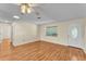 Bright living room featuring wood floors, a ceiling fan, and a large window for natural light at 511 Alcazar Ct, The Villages, FL 32159