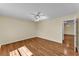 Bedroom featuring wood floors, a ceiling fan, and connected to another room in the house at 511 Alcazar Ct, The Villages, FL 32159