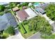 Real estate image featuring an aerial view of a house with a well-kept yard and verdant surroundings at 1819 Meadowbrook Ave, Lakeland, FL 33803
