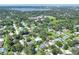 Aerial view of property in a lush residential neighborhood near a lake at 1819 Meadowbrook Ave, Lakeland, FL 33803