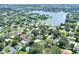 Beautiful aerial view of a lakeside neighborhood, showcasing lush landscaping and a home with a private pool at 1819 Meadowbrook Ave, Lakeland, FL 33803