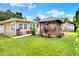 Backyard features a gazebo and lush lawn at 1819 Meadowbrook Ave, Lakeland, FL 33803