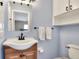 Charming bathroom with vanity, sink, mirror, decorative lighting, and toilet at 1819 Meadowbrook Ave, Lakeland, FL 33803