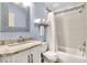 Stylish bathroom with shower, sink, vanity, and tiled walls at 1819 Meadowbrook Ave, Lakeland, FL 33803