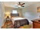 Comfortable bedroom featuring a neutral color palette, plush bed, overhead fan, and natural lighting at 1819 Meadowbrook Ave, Lakeland, FL 33803