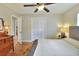 Inviting bedroom with hardwood floors, closet, ceiling fan, dresser, and plenty of natural light at 1819 Meadowbrook Ave, Lakeland, FL 33803
