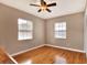 Bright bedroom with two windows, hardwood floors, and closet at 1819 Meadowbrook Ave, Lakeland, FL 33803