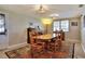 Inviting dining room features a wooden table, rug, and natural light from a window at 1819 Meadowbrook Ave, Lakeland, FL 33803