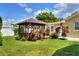 Cozy backyard with a gazebo surrounded by vibrant plants at 1819 Meadowbrook Ave, Lakeland, FL 33803