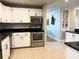 Well-lit kitchen boasts stainless steel appliances, white cabinetry, and black granite countertops at 1819 Meadowbrook Ave, Lakeland, FL 33803
