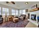 Cozy living room with a fireplace, comfortable leather seating, and vintage rug at 1819 Meadowbrook Ave, Lakeland, FL 33803