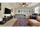 Cozy living room with large sofa, entertainment center, ceiling fan, and patterned rug at 1819 Meadowbrook Ave, Lakeland, FL 33803