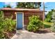 Charming shed with a blue door, surrounded by greenery at 1819 Meadowbrook Ave, Lakeland, FL 33803