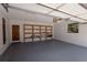 Spacious garage with shelving, painted floor and convenient storage, offering functionality and organization at 4428 Sugartree E Dr, Lakeland, FL 33813