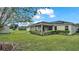 House exterior view showcasing backyard and solar panels at 7454 Briarbay Loop, Lakeland, FL 33810