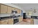 Modern kitchen featuring stainless steel appliances and wood cabinets at 7454 Briarbay Loop, Lakeland, FL 33810