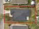Aerial view of property lines on a one-story home, showing the roof and surrounding yard with neighboring houses at 1217 Avenue J, Haines City, FL 33844