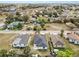 An aerial view of a cozy home in a neighborhood with lush greenery and clear blue skies at 1217 Avenue J, Haines City, FL 33844