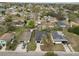 Aerial view of a one-story home, showcasing the roof, driveway, yard, and surrounding neighborhood at 1217 Avenue J, Haines City, FL 33844