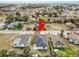 An aerial view of a cozy home in a neighborhood with lush greenery and clear blue skies at 1217 Avenue J, Haines City, FL 33844