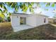 This backyard features a sliding glass door leading to a patio, perfect for outdoor relaxation and entertainment at 1217 Avenue J, Haines City, FL 33844