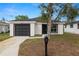 Charming single-story home featuring a gray garage door and a well-maintained front yard at 1217 Avenue J, Haines City, FL 33844