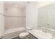 Well-lit bathroom with a shower and tub combination and a marble countertop sink at 2214 Oldham Ct, Haines City, FL 33844