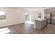 Bright kitchen with a stainless steel refrigerator, an island with a sink and gray cabinets at 2214 Oldham Ct, Haines City, FL 33844