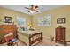 Comfortable bedroom features hardwood furniture, natural light, and a ceiling fan at 1175 E George St, Bartow, FL 33830