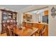 Cozy dining area with wood table, chairs, and a view into the kitchen at 1175 E George St, Bartow, FL 33830