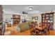 Inviting living room featuring hardwood floors, brick fireplace, and a stylish dining area at 1175 E George St, Bartow, FL 33830