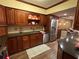 Modern kitchen with dark wood cabinets, granite counters, and stainless steel appliances at 17 Loma Verde # 17, Lakeland, FL 33813