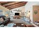 Living room with wood-beamed ceiling, fireplace, and comfortable furniture at 17 Loma Verde # 17, Lakeland, FL 33813