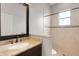 Bathroom featuring a vanity with granite countertops, framed mirror, and tiled walk-in shower at 5074 Shore Side Dr, Lakeland, FL 33812