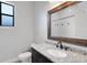 Bathroom featuring granite counters, dark cabinets, and shower at 5074 Shore Side Dr, Lakeland, FL 33812