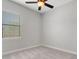 This bedroom includes carpet, a ceiling fan, and natural light at 5074 Shore Side Dr, Lakeland, FL 33812