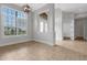 Bright foyer featuring neutral tile flooring, large windows, a decorative chandelier and an open floor plan at 5074 Shore Side Dr, Lakeland, FL 33812