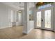 Elegant home foyer with built-in shelving, tile flooring, and decorative glass double front doors at 5074 Shore Side Dr, Lakeland, FL 33812