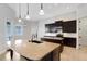 Open-concept kitchen boasts an island with bar seating, stainless appliances and pendant lighting at 5074 Shore Side Dr, Lakeland, FL 33812