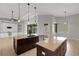 Gourmet kitchen featuring double islands, granite countertops, and stainless steel appliances at 5074 Shore Side Dr, Lakeland, FL 33812