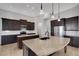 Spacious kitchen featuring a large center island with stainless steel appliances and dark wood cabinetry at 5074 Shore Side Dr, Lakeland, FL 33812