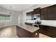 Kitchen features granite countertops, stainless steel appliances, and dark wood cabinets at 5074 Shore Side Dr, Lakeland, FL 33812