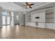 Spacious, bright living room with custom built-ins, tray ceilings, and decorative front doors at 5074 Shore Side Dr, Lakeland, FL 33812