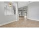 The neutral living space blends with light tile flooring and an adjacent room enhances the home's open feel at 5074 Shore Side Dr, Lakeland, FL 33812