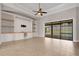 Bright living room with built-in shelving and sliding glass doors to the pool at 5074 Shore Side Dr, Lakeland, FL 33812