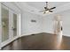 This living room features tile floors, white trim, a ceiling fan, and backyard access at 5074 Shore Side Dr, Lakeland, FL 33812