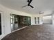 Spacious covered brick paver patio with ceiling fans and sliding glass doors to the interior at 5074 Shore Side Dr, Lakeland, FL 33812