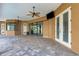 The large outdoor patio features a ceiling fan and sliding doors, offering a seamless transition to indoor living at 5074 Shore Side Dr, Lakeland, FL 33812