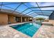 Enjoy a leisurely swim in the screened-in pool, complete with a spa and a paved patio for lounging at 5074 Shore Side Dr, Lakeland, FL 33812