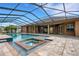 The pristine pool and spa area offers a refreshing escape, with a paved patio and screened enclosure at 5074 Shore Side Dr, Lakeland, FL 33812